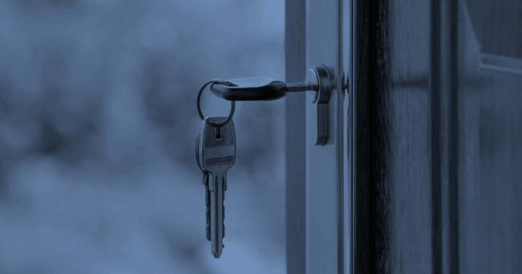 Keys in door of house